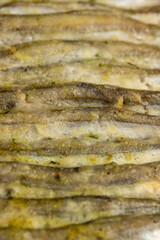 capelin fish fried in plenty of oil, stacked in rows cooked capelin baked in sunflower oil in the oven