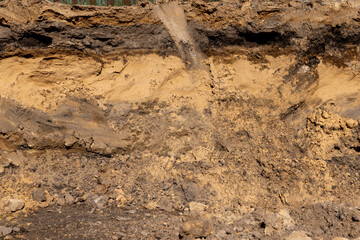 a part and a closeup of the excavated pits during construction work on the road