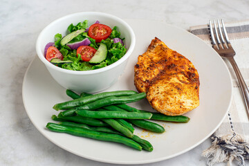 seasoned chicken breast  with green beans and salad