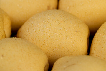sweet fresh white pear in the kitchen closeup, in drops of water, side view