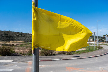 A yellow flag flutters gently in the wind, representing hope for the release of hostages in Israel....