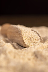 a large amount of wheat flour with bran without peeling, flour in a spoon