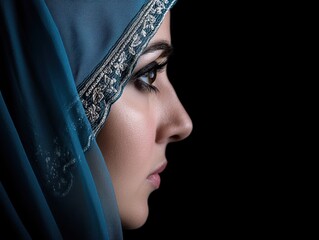 Woman in teal headscarf profile