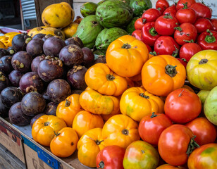 Fresh, colorful fruits such as passion fruit, tree tomatoes, and naranjilla displayed in a market setting, highlighting Ecuador's agricultural biodiversity.