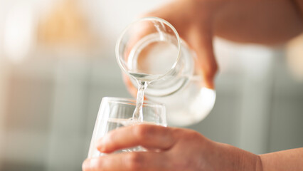 Woman holding a glass of drinking water
