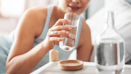 Woman holding a glass of drinking water