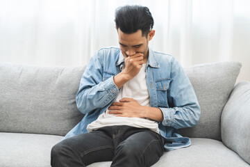 Flatulence ulcer, hurt suffer asian young man, male hand in belly, stomach pain, ache from food...