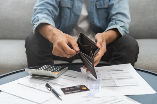 Debt financial concept, stressed problem people asian man, male hand open empty wallet not have budget of money to pay no have credit card, not able payment bill, loan or expense with bank, bankruptcy