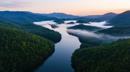 A serene river winds through lush green forests and misty hills at sunrise.