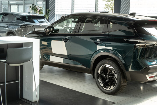 Modern cars in the showroom of a car dealership. Plotting the purchase or sale of a modern automobile. 