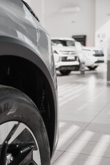 New cars are on display in a modern showroom. Concepts for car sales, leasing or insurance services.