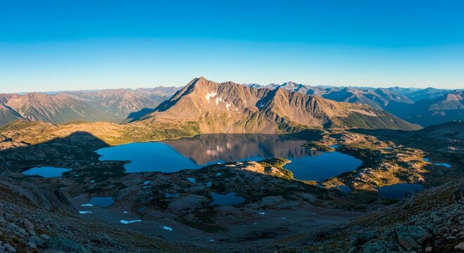 Aerial view of mountain range and lakes under clear blue sky at daytime