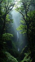 Lush waterfall cascading down a misty, verdant canyon