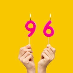 Birthday number 96 - Hands holding fuchsia colored candles