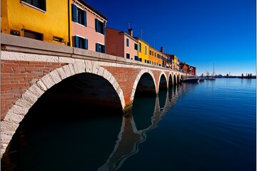 Picturesque bridge reflects vibrant buildings in venetian waterway