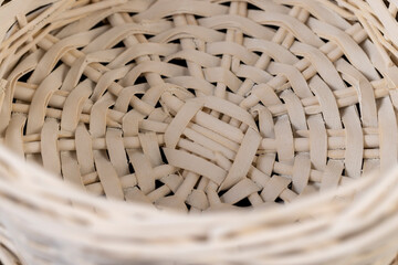 details of a white basket for food or other items, natural branches painted white from which a...