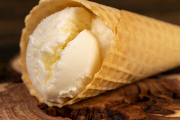 cup with ice cream on a board, cold and sweet vanilla ice cream made from cream with sugar
