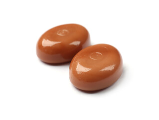 Tasty sweet caramel candies isolated on white