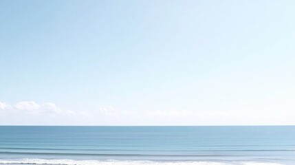 Obraz premium Pale blue ocean and sky with soft clouds.
