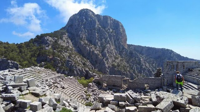 4K Travelers exploring the ancient theater (amphitheater) ruins at Termessos, Pisidian city hidden in the Taurus Mountains (Gulluk Mountain) near Antalya, Turkey