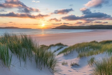 Golden sunset over a pristine white sand beach, framed by dunes and grass.