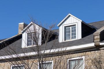 Roof of a residential building. Dormer windows or attic of a house