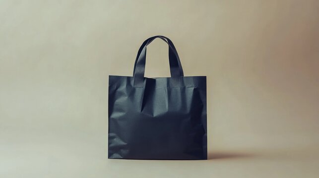 Plain black tote bag on a light beige background