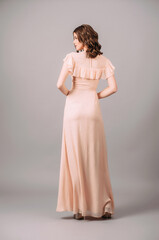 Short sleeve evening dress with ruffle neckline in ivory. Gorgeous sexy lady with curly hairstyle....