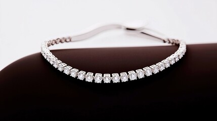 Fototapeta premium Elegant, diamond-studded bracelet resting on a dark surface.