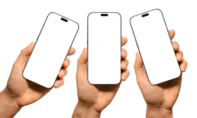 Hands holding smartphones with blank screens on a white background, ideal for mockups or digital presentations.