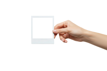 A hand holds a polaroid blank picture isolated on transparent background 