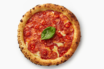 Delicious pepperoni pizza with chili peppers and basil on white background