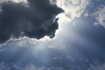 Sunset with sun rays. light because of a beautiful dark cloud. Hope, a sense of miracle