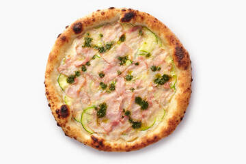 Round pizza with pesto, zucchini, bacon and melted cheese baking on a white background
