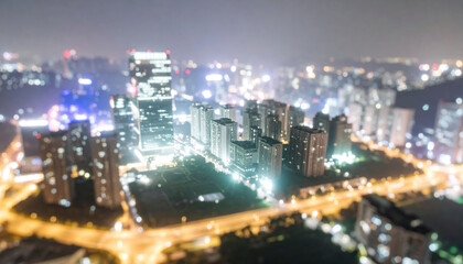 Fototapeta premium Blurred night cityscape with illuminated buildings and streets