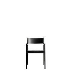 Fototapeta premium A modern black chair with a sleek design stands out in a minimalist setting
