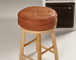 Round leather cushion resting on wooden stool: interior design inspiration