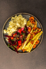 Enjoy a hearty breakfast or lunch with millet, baked zucchini, and carrots, paired with a fresh salad of seasonal vegetables and herbs, for a delicious vegetarian meal