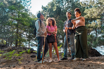 Group of friends hiking in the forest enjoying nature adventure