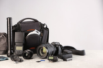 Professional photographer's equipment and case on light table. Space for text