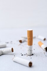 Many cigarette butts on light background. Smoking habit
