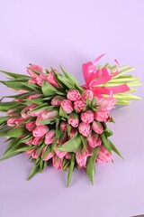 Bouquet of beautiful tulips on lilac background