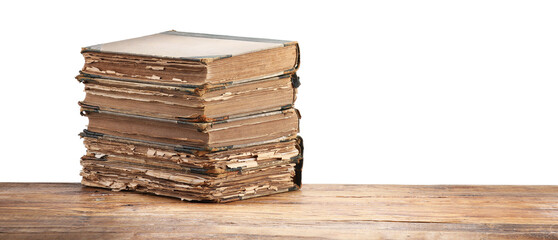 Old books on wooden table against white background