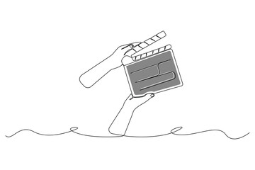 Hands holding a clapper board line art drawing. Holding a clapper board linear icon vector.