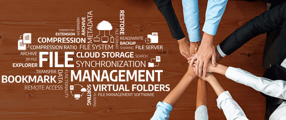 An overhead view of teamwork focused on file management, emphasizing cloud storage,...