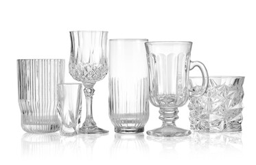 Different empty clean glasses isolated on white