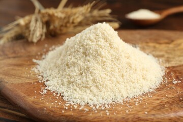 Pile of flour and spikes on wooden table, closeup