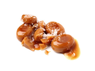 Tasty sweet candies, salt and caramel sauce isolated on white