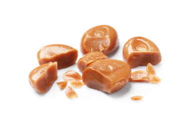 Broken tasty caramel candies isolated on white