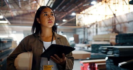 Construction, woman and engineer thinking with tablet for woodwork, insight and vision for renovation. Technology, planning and carpenter working in warehouse to check stock for building development © DavidL2000/peopleimages.com